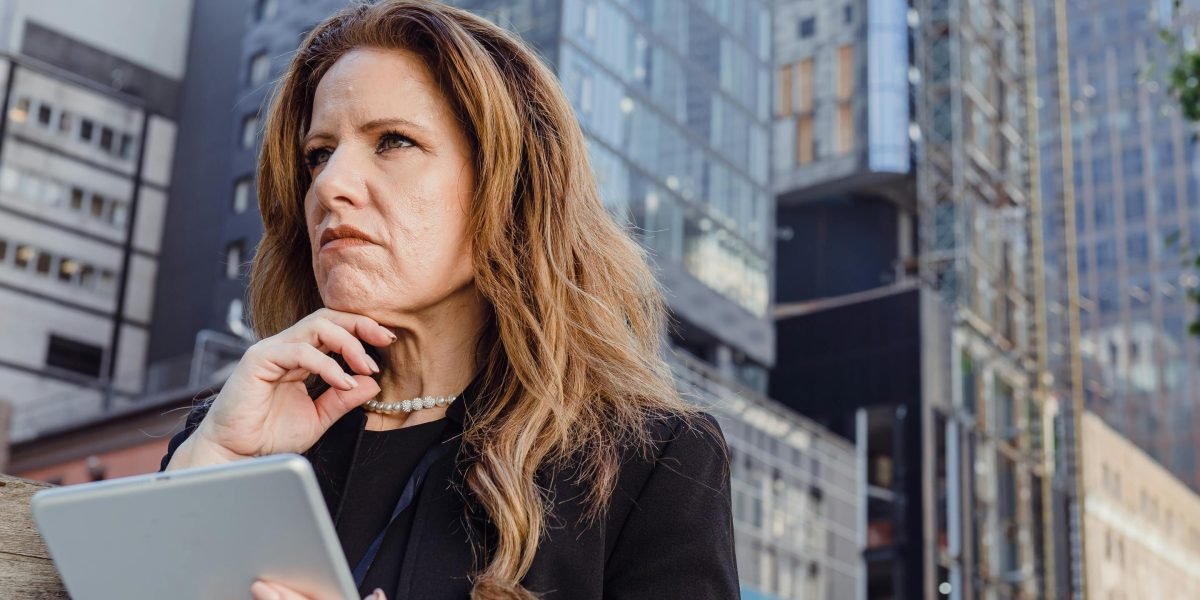 A person reviewing documents with a thoughtful expression, ready to make an informed decision about property investment.