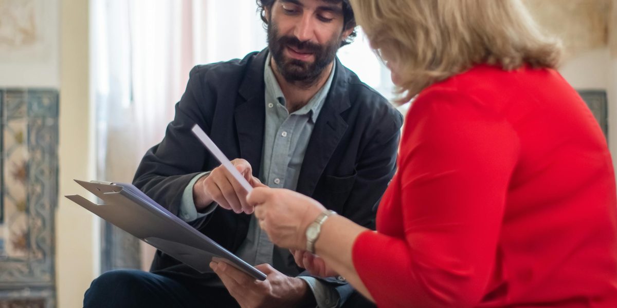 An expert guides a client through complex real estate decisions in a professional setting.