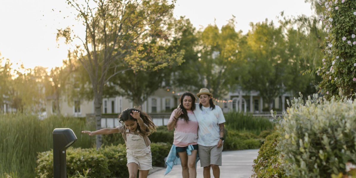 A family enjoying recreational activities in a lush, master-planned community park.