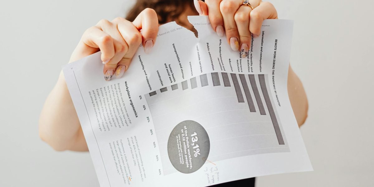 A person looking frustrated while reviewing documents, illustrating the challenges of dealing with unprofessional agents or issues.