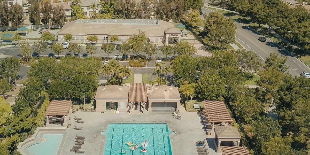 Residents enjoying various amenities like a swimming pool and green spaces in a luxury community.