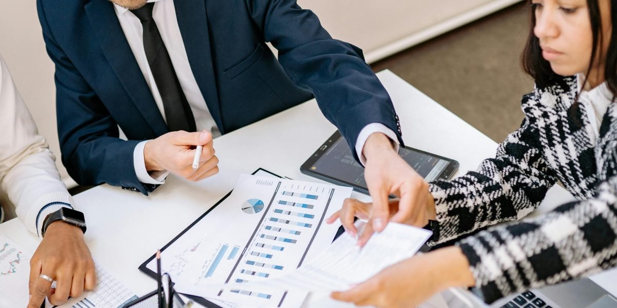 Professionals evaluating key factors and discussing options for choosing the right real estate brokerage.