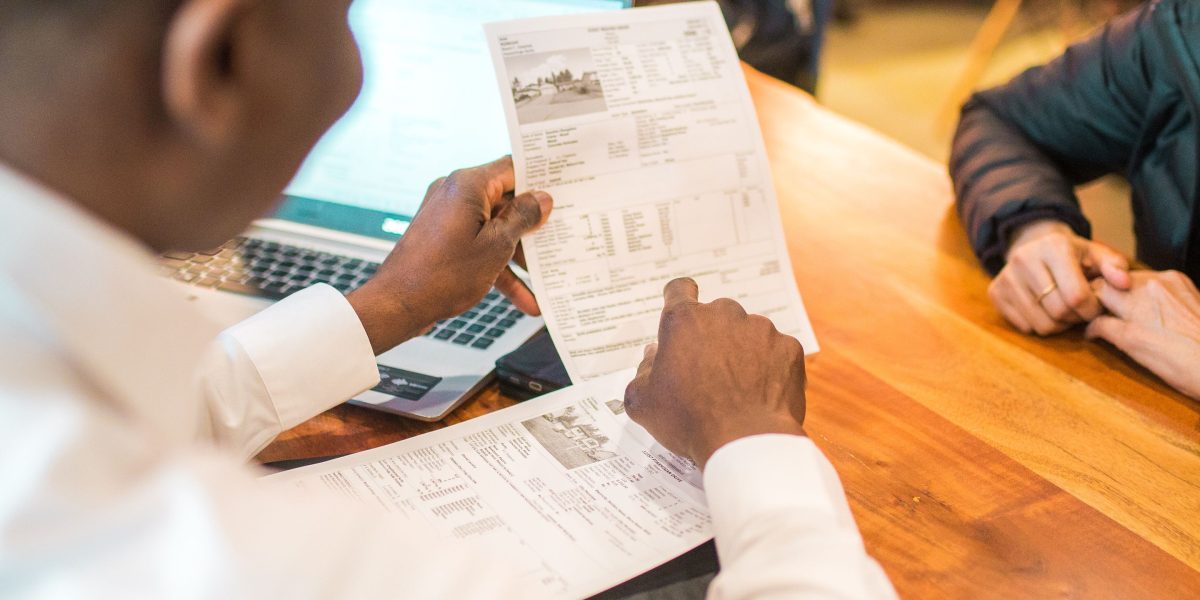 A real estate advisor guiding a client through various property options and explaining key considerations.