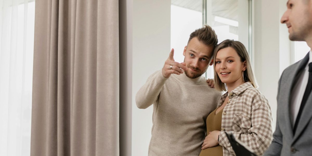 A couple exploring the interiors of a modern luxury villa, visualizing their family's future in the space.