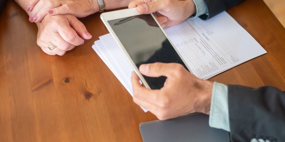 A couple consulting with a financial expert about property financing and legal aspects.