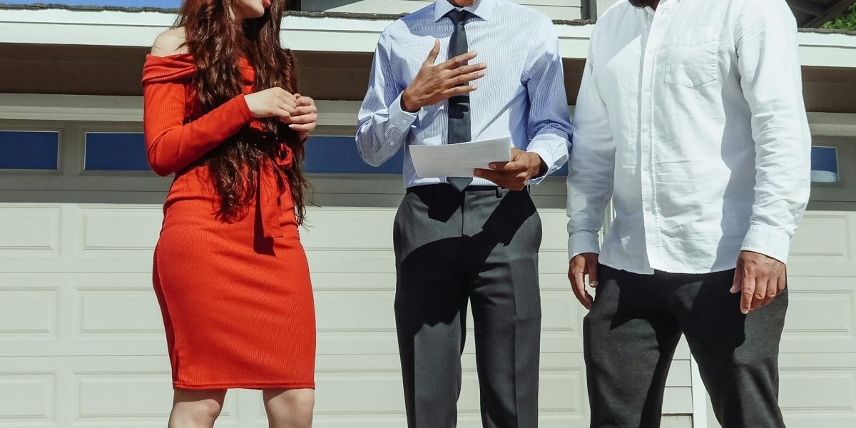 An agent and clients engaging in a confidential and professional real estate consultation.