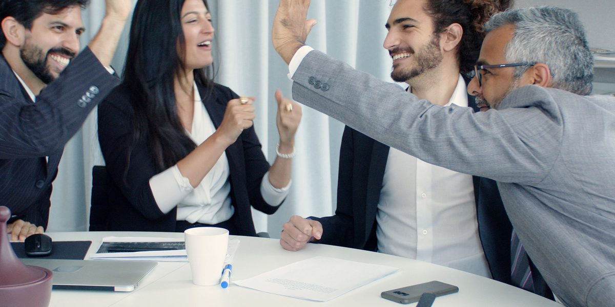 A team celebrating a significant achievement, reflecting the rapid success and demand in the tokenized real estate market.