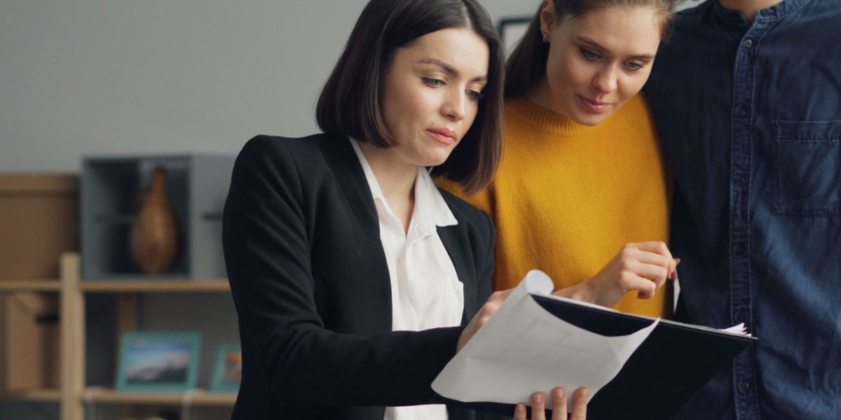 A couple consulting with a real estate agent to get expert guidance on property options and market trends.
