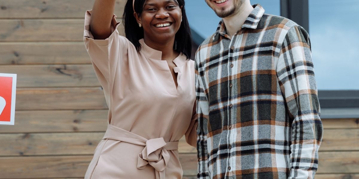 The joyful moment of a couple receiving keys to their new luxury villa, signifying a successful transaction.