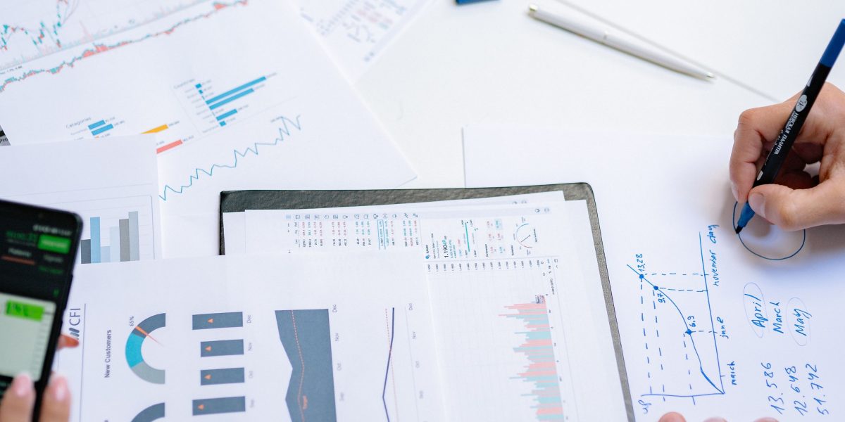 A team of professionals collaborates to analyze market data, strategizing for optimal returns on real estate investments.