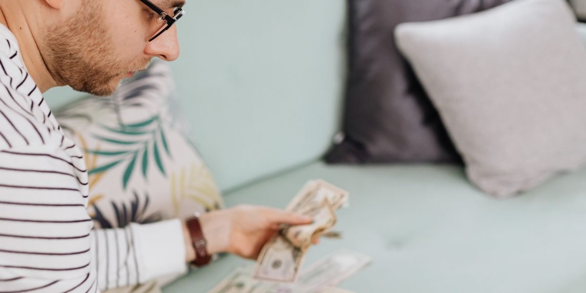 A person deep in thought, reviewing financial documents, symbolizing the careful consideration of investment opportunities.