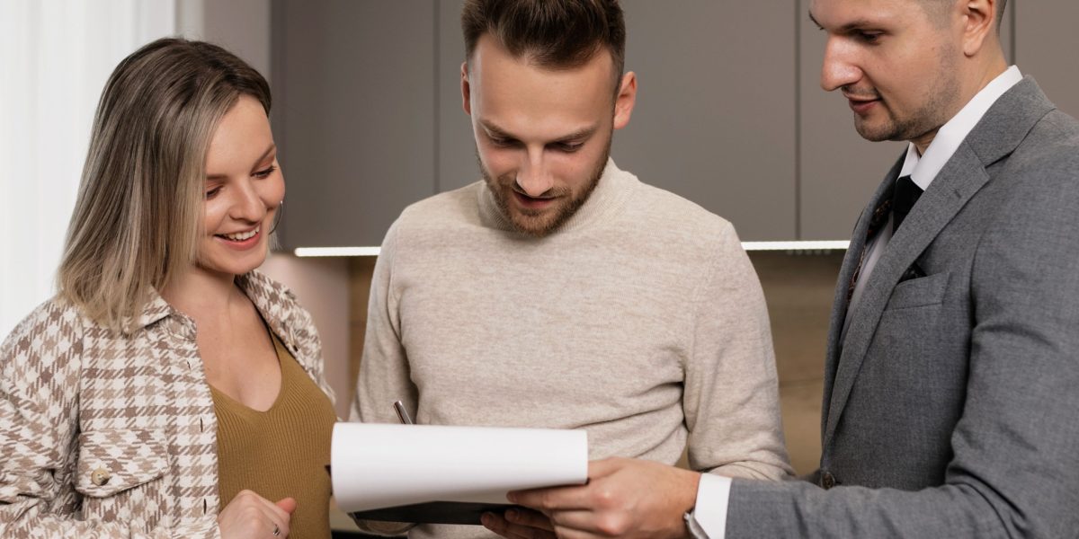 People engaged in a conversation about property investment, possibly with an advisor, in a professional setting.