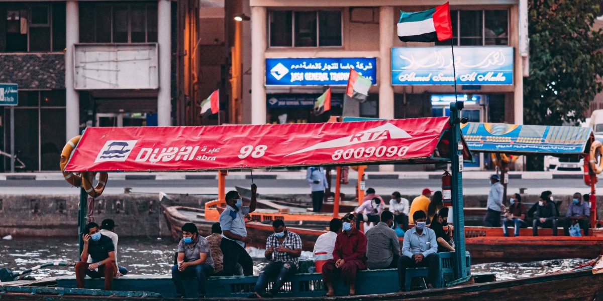 Passengers enjoying a timeless journey on a traditional abra across Dubai Creek.