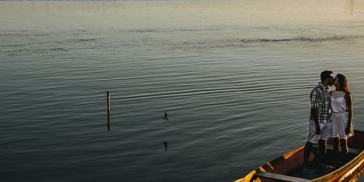 A couple enjoying a serene private abra ride during sunset over Dubai Creek.