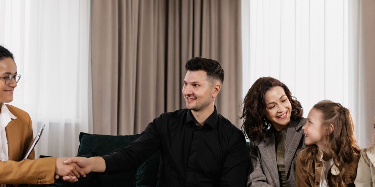 Two professionals sealing a high-value real estate deal with a handshake, representing trust and agreement.