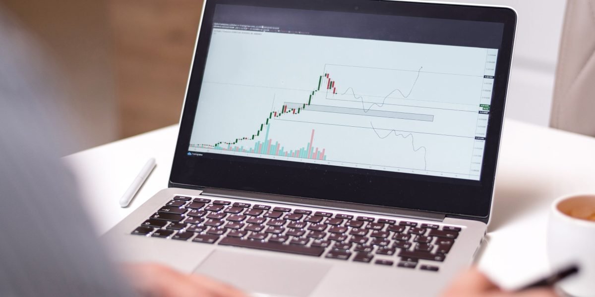 An investor thoughtfully reviews documents, considering future opportunities in real estate.