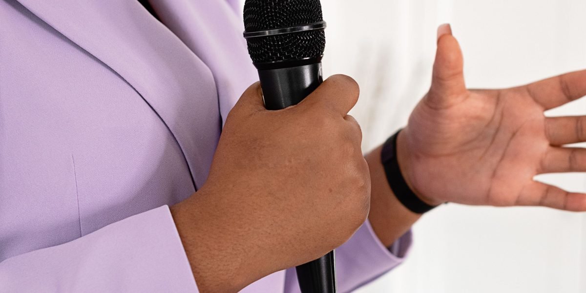 A professional confidently presenting in a modern office environment, symbolizing the high-end appeal of Downtown Dubai.
