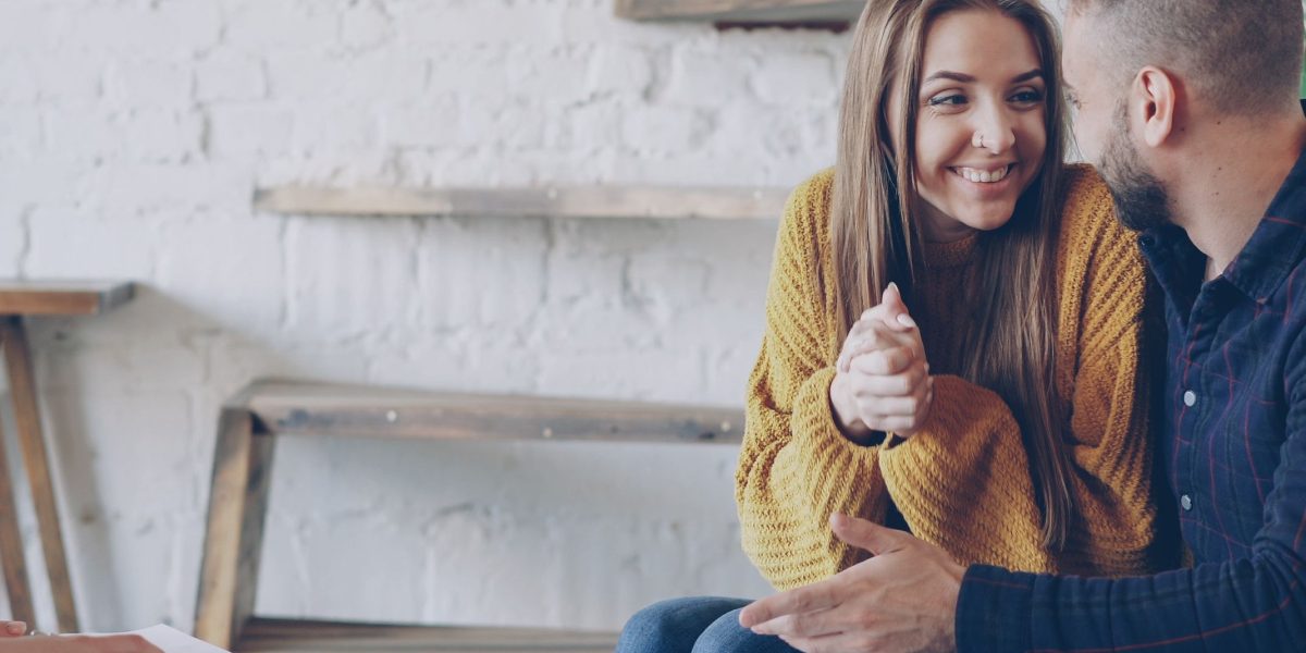 Couples or families carefully considering floor plans and lifestyle needs for their new home.