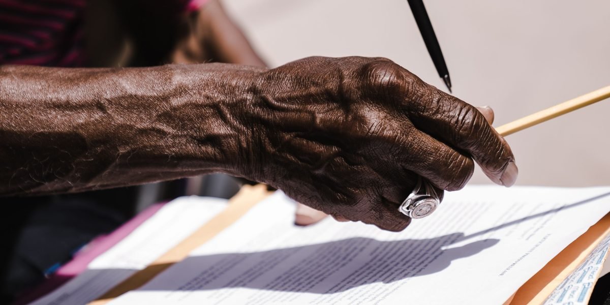 A professional setting where individuals are reviewing and signing important legal documents.