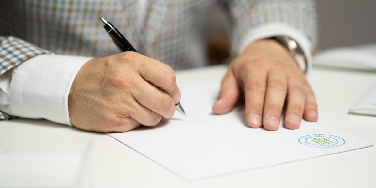 An individual thoughtfully reviewing documents, symbolizing the complexity of Dubai's regulatory landscape for villa buyers.