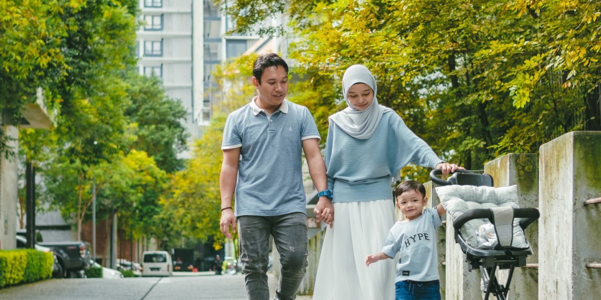 A family enjoying a peaceful, green space within a modern, oasis-style community in Dubai.