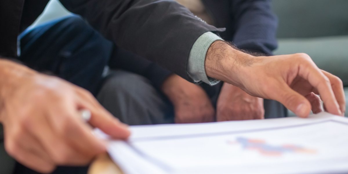 A client reviews legal documents with their real estate advisor, ensuring a smooth transaction process.