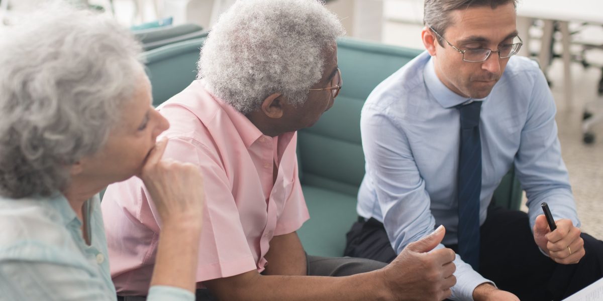 A couple engaged in financial planning, considering rental yield and investment strategies for their property.