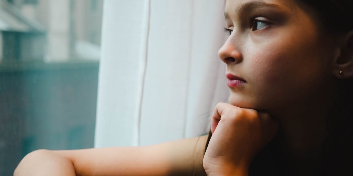 A person reflecting on important decisions, symbolizing the careful consideration needed when selecting a real estate brokerage.
