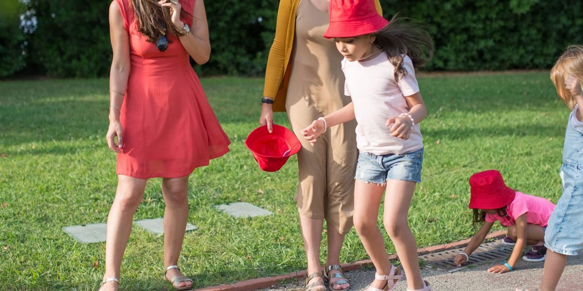Parents observe their children playing happily in a safe, private community park, reflecting the family-focused amenities and security of Dubai's luxury villas.