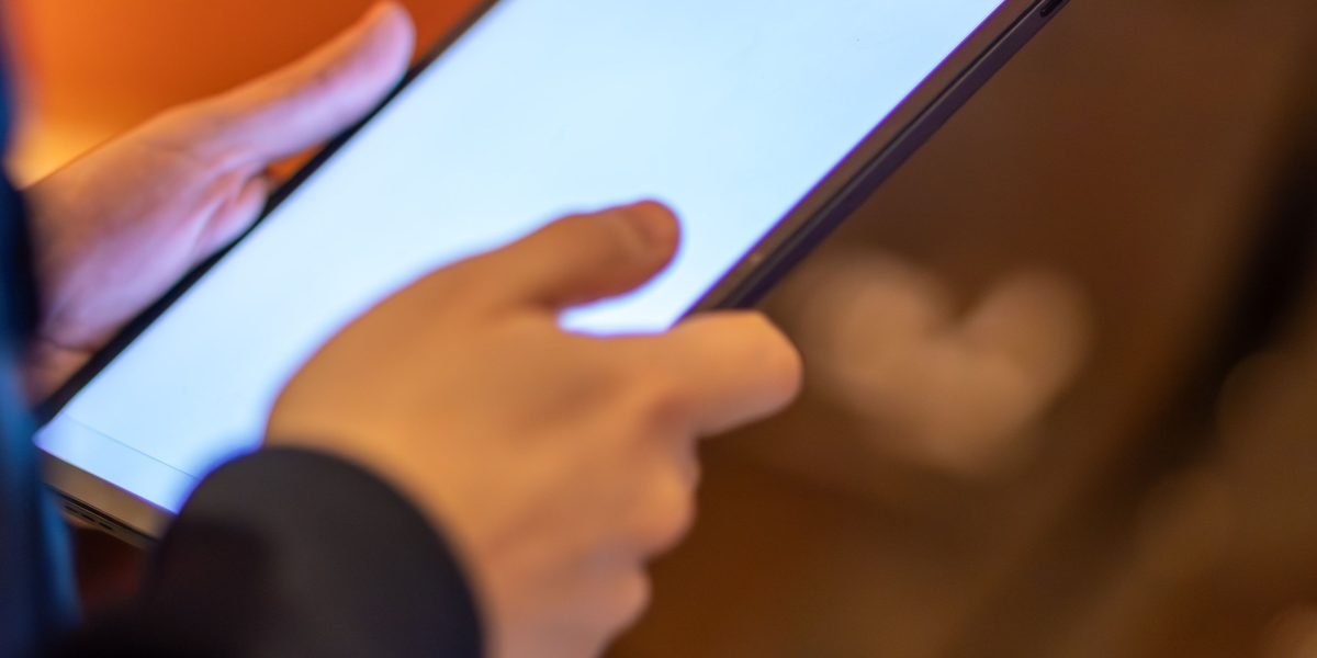 A buyer diligently checking agency credentials and reviews online before making a decision.